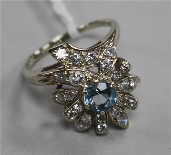 A modern 14ct white gold, aquamarine and diamond set flowerhead dress ring, size T/U.